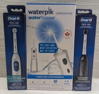 New Waterpik Cordless Plus - Waterflosser - Box Has Damage and 2 Oral-B - Pro 100 Electric Toothbrushes - 1 Brush Infused With Charcoal - 1 Brush is Sensitive Gum Care