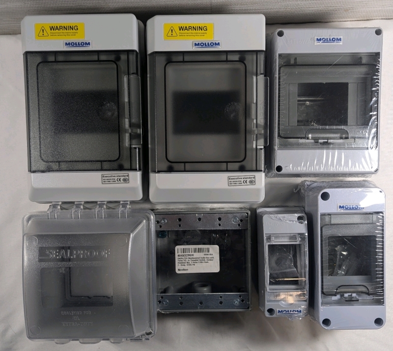 New: Assorted Electrical Equipment - 2 Mollen 4 Way Distribution Box - 1 Mollen 5 Way Circuit Breaker - 1 Mollen 3 Way Circuit Breaker - 1 Sealproof Outlet Cove - 1 Mollen 2 Way Circuit Breaker - 1 Enerlites Weatherproof Outlet Box With 3 1/2 in Threaded 