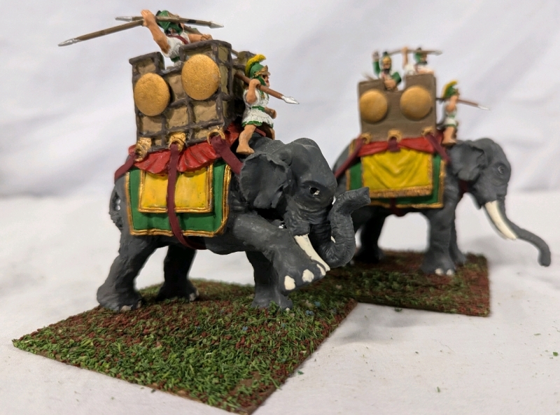 2 Resin Elephant Figures with 3 (Total) Lead Riders. 3.75" Tall. On Flocked Base. Hand-painted