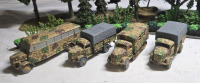 ( 4 ) Appears To Be Plastic/ Metal German Military Trucks | Including But Isn't Limited To Half Track, Opel Transport Trucks & Opel Blitz Omnibus | Largest Measures 3¾" x 2½" * Shrubbery Not Included *