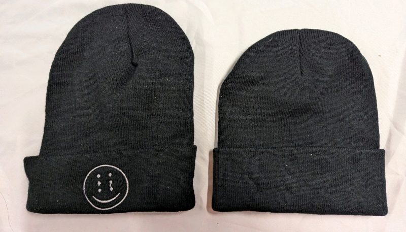 2 Alien Smiley Beanies/Touques. No size listed. One is 9.5" From Bottom of Logo to Top of Hat, Other is 8.5".