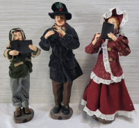 Festive Christmas Caroling Family Figures . Measures 13" to 16" tall . Dad missing song book