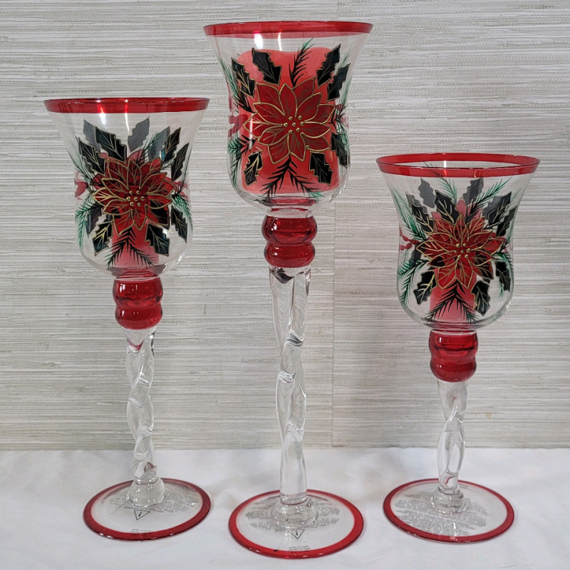 Three (3) Festive Christmas Glass Candle Holders with Battery Candles . Measures 11.5" to 15.5" tall . Candles require batteries