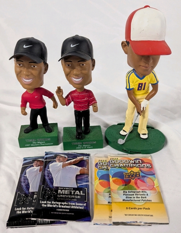 3 Tiger Woods Bobble Heads 2 New 2023 Skybox Metal Universe Champions Trading Card Packs & 2 New Uppdeck Goodwin Champions Trading Card Packs.