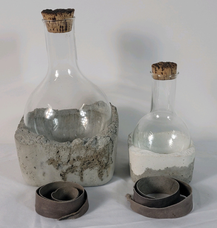 Studio 50 Rock Bottom Wine Decanters with Cork Tops . Leather Wraps Included , not attached . Rock Bottom placed in freezer to keep wine chilled when decantor in use