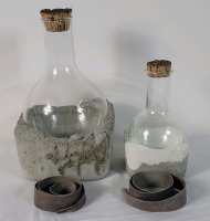 Studio 50 Rock Bottom Wine Decanters with Cork Tops . Leather Wraps Included , not attached . Rock Bottom placed in freezer to keep wine chilled when decantor in use