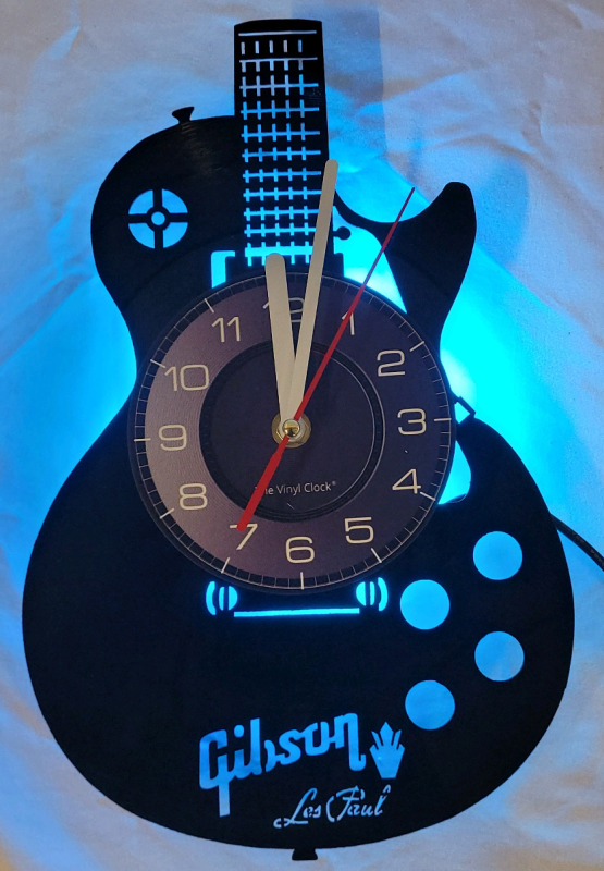 New - Gibson Les Paul Vinyl LP Wall Clock w/LED Back-Light & Remote . Measures 12" . Requires One (1) AA Battery (not included)