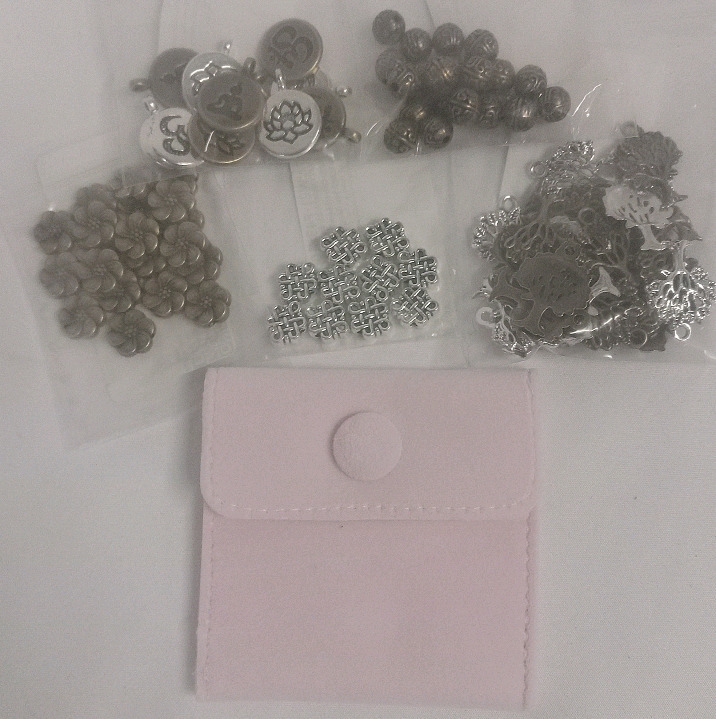 New | Over 30 Pcs Assorted Charms & Mini Jewelry Bag in the Color Pink