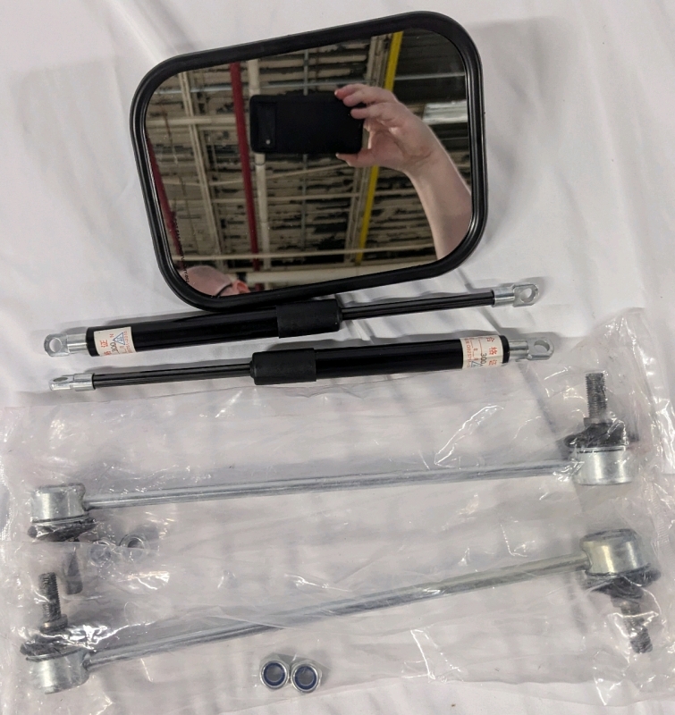 New Auto Part Lot. 2 Front Stabilizer Links (Model Unknown). 2 11" Gas Prop Strip. And one Rear View Mirror 7" across.
