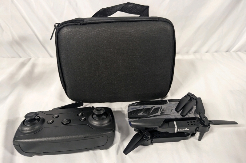 New E99 Folding Drone With Controller and Case. Drone Body Measures 5" Long.