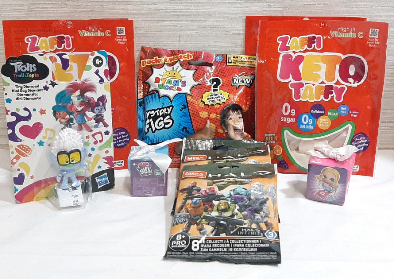 Lot of Various Mystery Toy Packs and Taffy Candy, Including a Ryan's World Mystery Figs Mystery Pack, 3 Halo Mega Construx Mystery Packs, 2 Giftem Mystery Packs, Trolls: Trollstopia Tiny Diamond Figure & 4 Bags of Zaffi Keto Taffy, 1.6oz in each pack