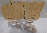 New Dolly Brand Kitchen Lot. 4 Bamboo Cutting boards and 4 Wooden Spoons. Cuttingboards measure 10" Tall.