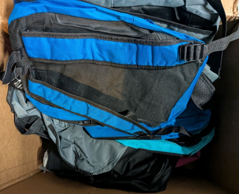 12 Back to School Care Package Backpacks. each Bag Contains a Variety of Back to School Supplies.