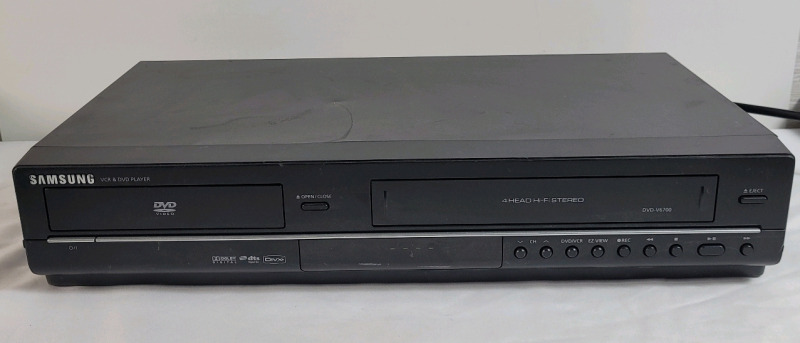 Samsung VCR & DVD Player Combo , Model # DVD-V6700 . Tested Powers Up , Not Tested Beyond Power Up . DVD Door Opens & Closes . No remote . Small bent on top