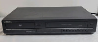 Samsung VCR & DVD Player Combo , Model # DVD-V6700 . Tested Powers Up , Not Tested Beyond Power Up . DVD Door Opens & Closes . No remote . Small bent on top