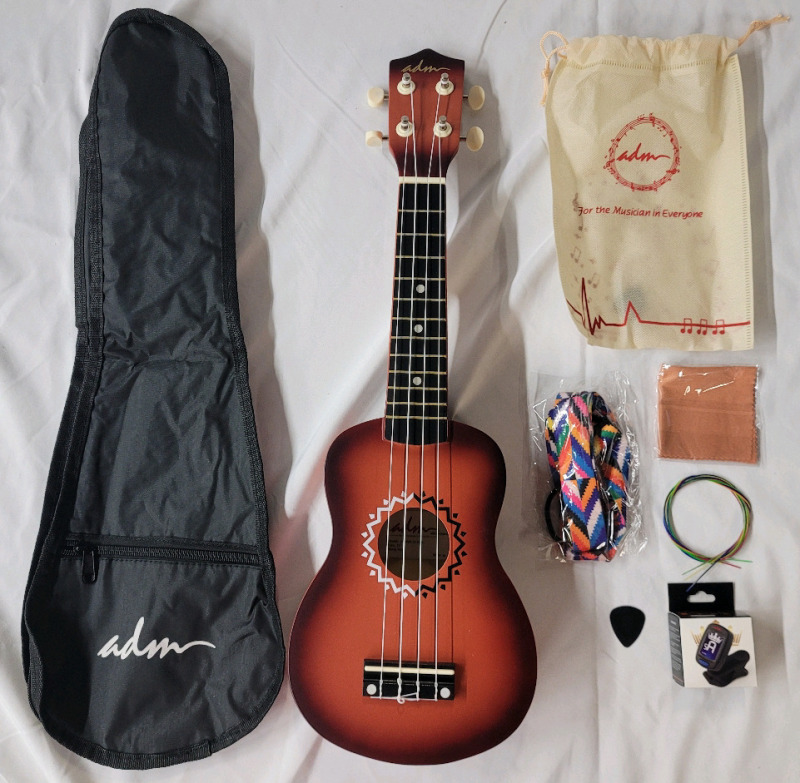 New - ADM Ukulele w/Travel Bag & Accessories . Model # JU110N-21-SBR