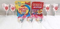 Lot of Candy Bags & Candy Sticks, Including Mini Swedish Fish (340g each, Best Before October 2025), Haribo Berry Hearts (88g each, No Best Before), 4 Marshmallow Jelly Pops (45g each, Best Before December 2025) & 3 Heart Lollipop Bouqets (50g each, Best 