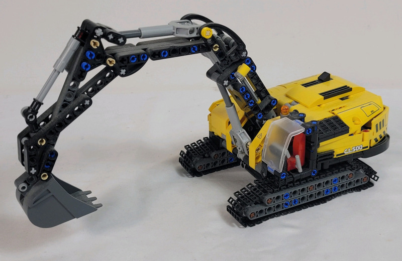 LEGO Technic Heavy-Duty Excavator Build Set , # 42121 . Assembled , 565 pcs. Appears Complete , Missing 4 red pylons . Some dust from display . Measures 12"&times;4.5"