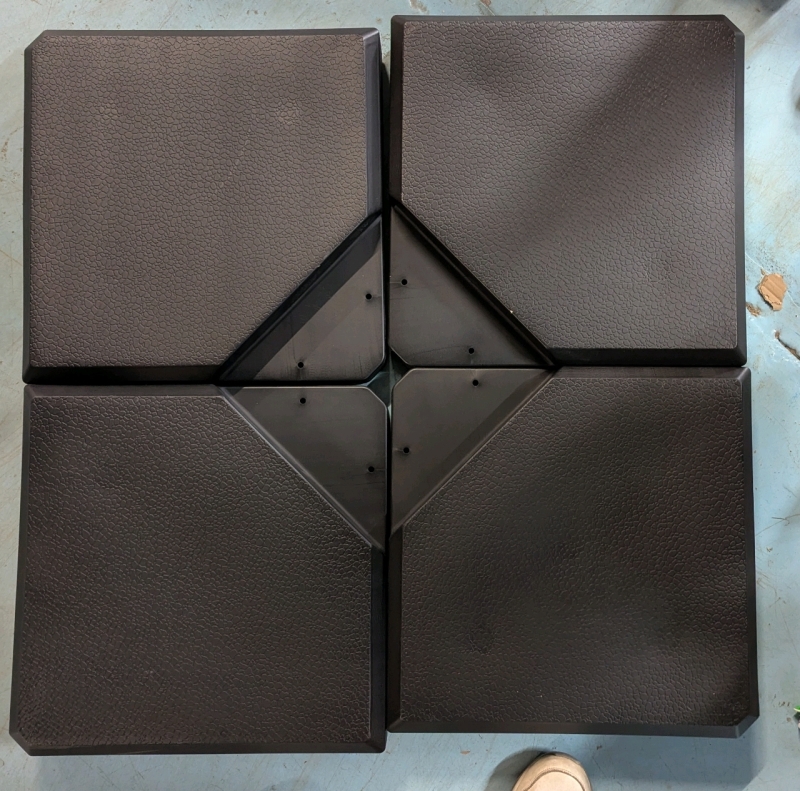 As is - As New -Plastic Weighted Umbrella Stand. Each Quarter Measures 19" x 19" by 3.5"