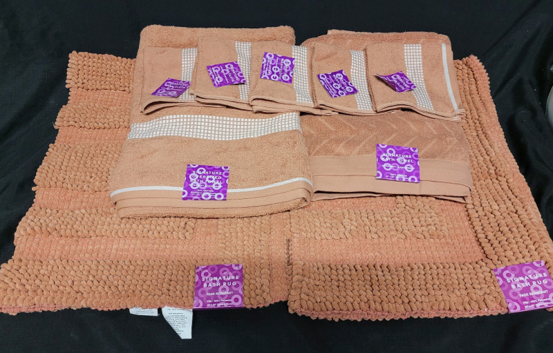 New - Signature Apricot Towels (2) , Face Clothes (5) & Bath Mats (2) . Nine (9) Pieces
