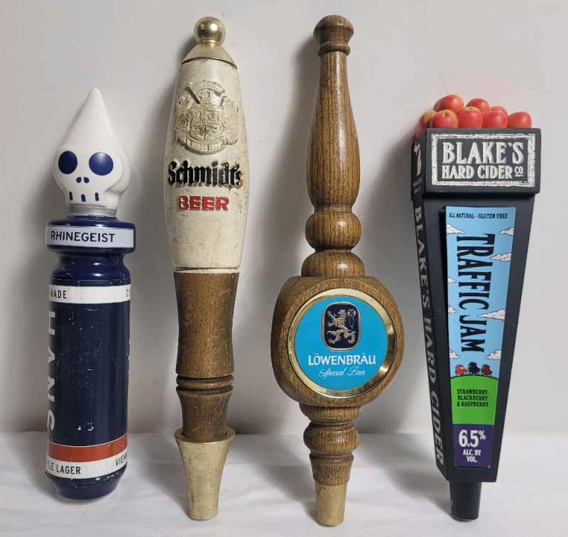Four (4) Bar Beer Taps . Hanes Rhinegeist , Schmidts , Lowenbrau & Blake's Hard Cider Co. . Measures 10 1/4" to 12" tall