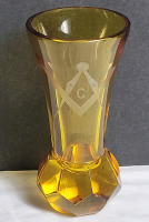 Vintage Art Deco Amber-Colored Glass Vase Featuring a Geometric Design on the base and a Masonic Square and Compass Symbol Etched on the body . Measures 7 3/4" tall . No chips or cracks