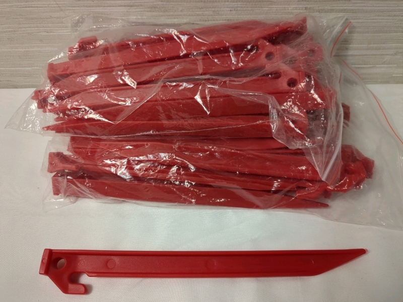 2 New Packs Plastic Tent Pegs Approx 24 per pack.