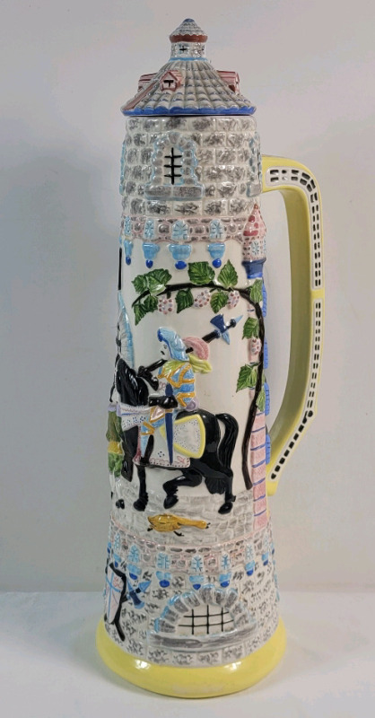 Vintage 1979 Ceramic Pitcher w/Lid . Knight on Horse w/Castle Tower & Peasants . Measures 19" tall . Lid has small chip