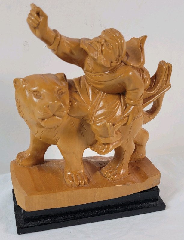 Wooden Hand Carved Man Riding Tiger on Base . Measures 5 1/4"&times;7"
