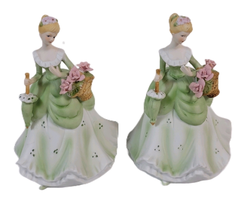 Two (2) Vintage Porcelain " Lady w/Umbrella & Flower Basket " Figurines . Measures 7" tall each . Giftcraft Toronto Sticker on Bottoms