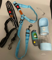 2 New elasticated, adjustable dog seatbelts, poop bag holder with 1 roll of bags, travel water bottle with food cup.