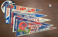 6 Pieces of Buffalo Bills Memorabilia. 5 Pennants and One Helmet Graphic. Pennants Measure 30" Long.