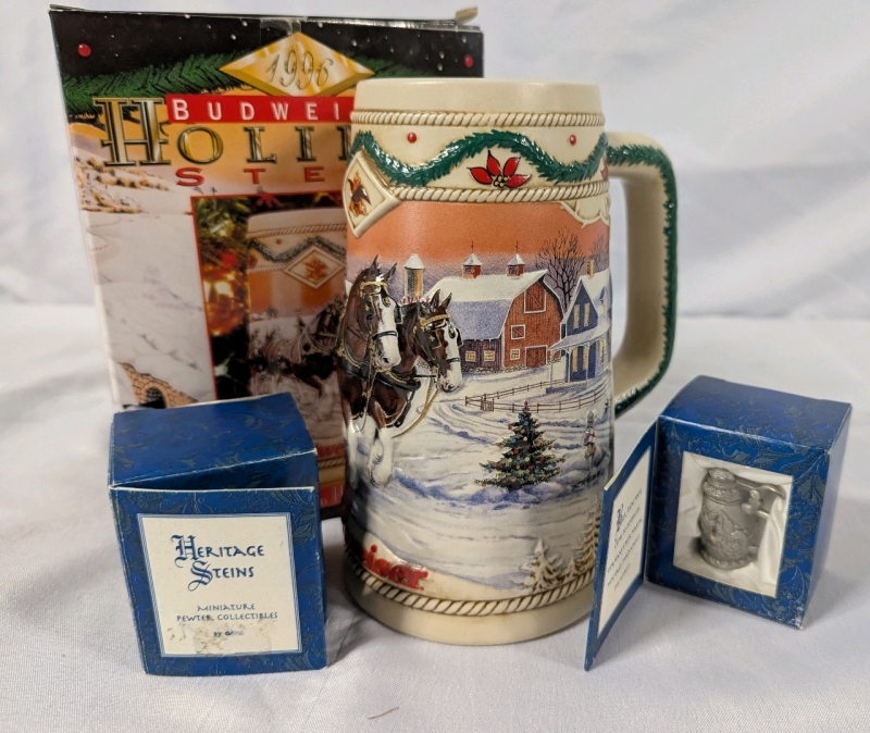3 Vintage Steins. 2 Ganz Vintage Pewter Heritage Steins & 1996 Budweiser Holiday Stein. All Steins come with box.