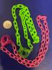 Two Acrylic Handcuff Glowing Retro Fabulous Necklaces One Bright Green One Bright Pink approximately 17 inch - 6