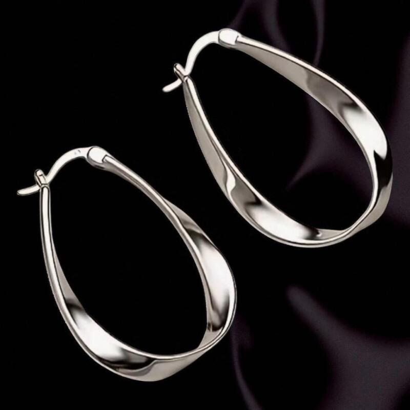 Elegant Earrings S925 Silver Moire Twist Design Snap down clasp Stamped Appropriately 1.25&rsquo;&rsquo; drop Stock photos added with model