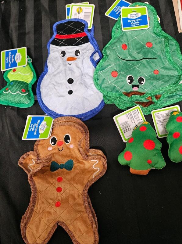 11 new dog toys. 2 gingerbread flattie toys, 2 plush trees, 1 durable tree, 2 snowman flattie toys, 4 tree flattie toys
