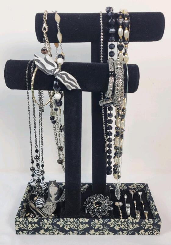 Assorted Rings , Brooches , Bracelets & Necklaces with Jewelry Stand .