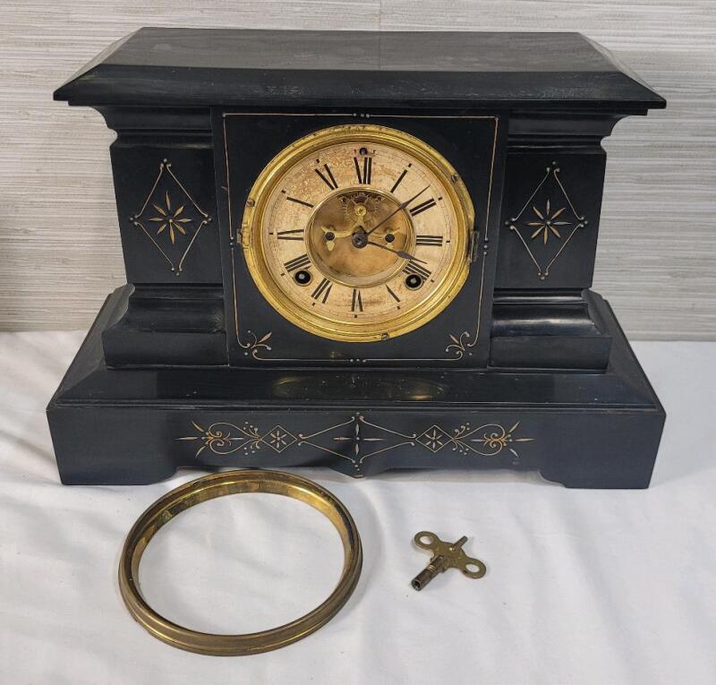 As Is - Antique Ansonia Black Cast Iron Mantle Clock w/Key . Patented June 1881 . Chimes on the Hour & Half Hour , Pendulum Swings , Mechanism on Face Rotates , Key Mechanism on Clock Face both Rotate . Face Door Needs Replacing & Needs New Clock Arms . H
