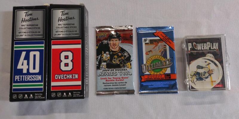 Tim Hortons Superstar Collectible Sticks: Two boxes containing collectible sticks featuring NHL players Elias Pettersson and Alexander Ovechkin, Upper Deck Series Two Hockey Trading Cards, Ultimate Hockey card pack, and PowerPlay cards