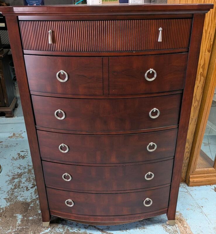 Somberton Tall Boy Dresser. Minor scuff present from use. Measure 56" Tall, 40" Wide and 20" Deep.