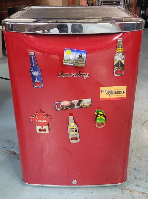 Danby Red Mini-Fridge w/Bottle Opener Magnets . Flat top to rest drinks and snacks . Measures 17.5"&times;27"&times;19" . Tested Working . Would benefit from cleaning before use