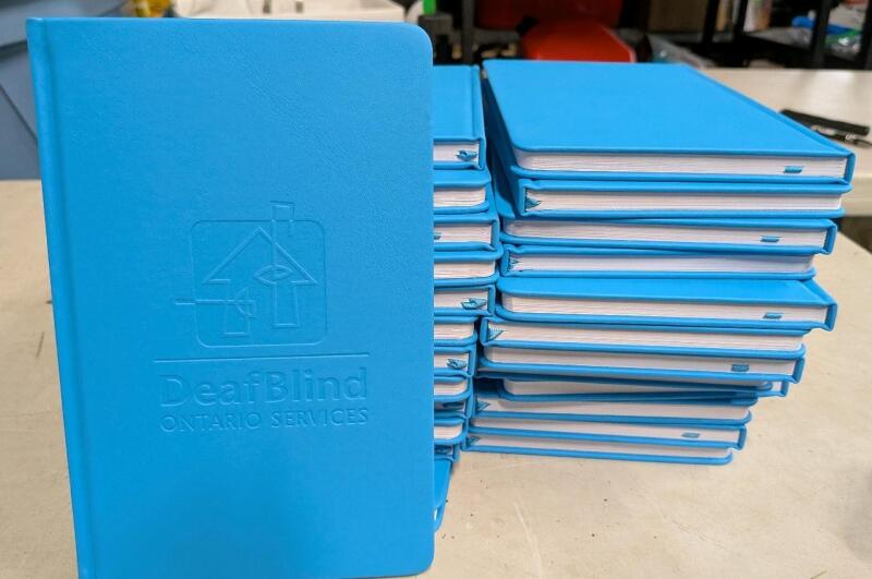 25 New Lined Journals Embossed with "Deafblind Ontario Services" 5.25" by 8.25"