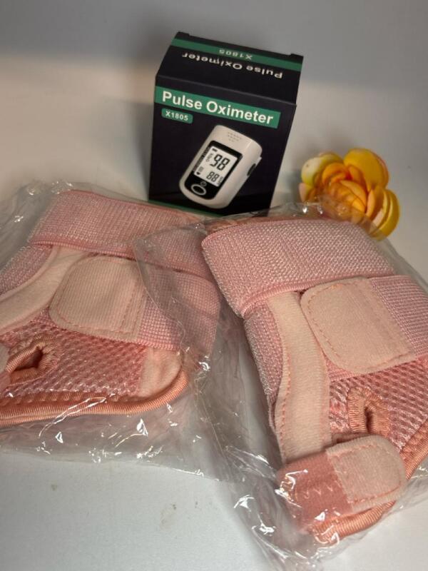 New 2pcs Universal Thumb Brace in Pink - Supports Left or Right Hand, Fits Men and Women / New Pulse Oximeter Stock photos of Brace