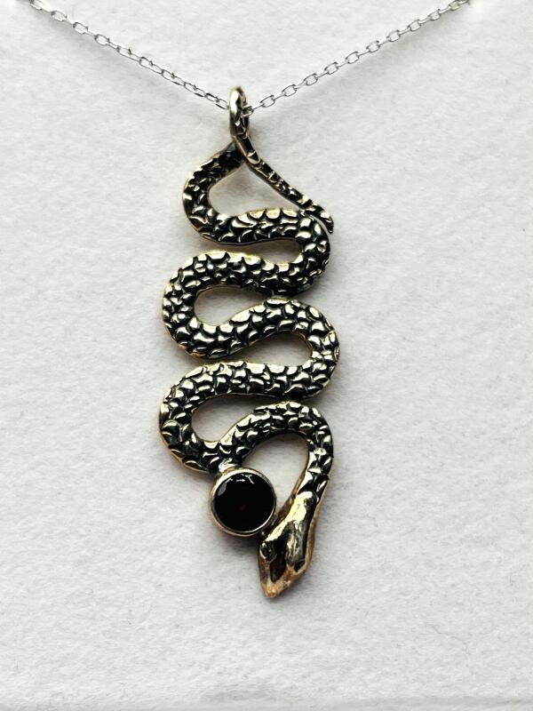 Sterling Silver Snake Shape Pendant and Natural Garnet with Sterling Silver Chain, Retail $350.00.
