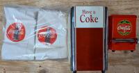 Vintage to Newer Coca-cola Products. Napkin Dispenser, Tooth Pick Dispenser, and Coca-Cola Napkins. Napkin Dispenser Measures 17" Tall.