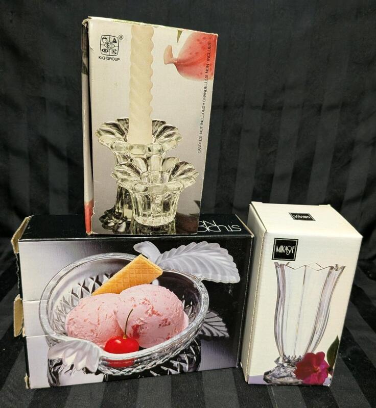 4 Clear Glass Pieces in Original Box. 2 Kig Group Candle Stick Hokders, 1 Studio Nova Apple Candy Dish and 1 Mikasa bud Vase. Bud Vase Measures 5" Tall.