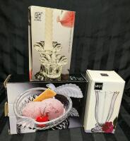 4 Clear Glass Pieces in Original Box. 2 Kig Group Candle Stick Hokders, 1 Studio Nova Apple Candy Dish and 1 Mikasa bud Vase. Bud Vase Measures 5" Tall.