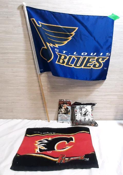 Lot of NHL Sports Memorabilia, Including St. Louis Blues Flag, Calgary Flames Towel, Upper Deck 2024-25 Series Two 4-Card Pack & 2.5" Figurine