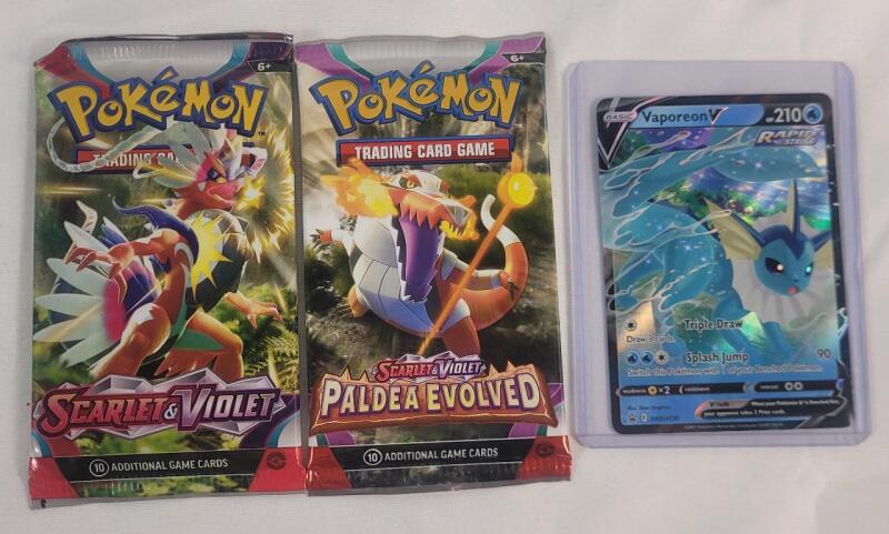 Two (2) New Pok&eacute;mon TCG Scarlet & Violet Sealed Packs and Pok&eacute;mon TCG " Vapoeon " Holo Game Card
