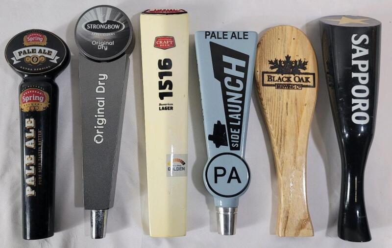 Six (6) Beer Taps . Okanagan Spring , Strong Bow , Side Launch , Black Oak & Sapporo . Measures 9 &frac14;" - 10 &frac34;" tall . Wear from use .